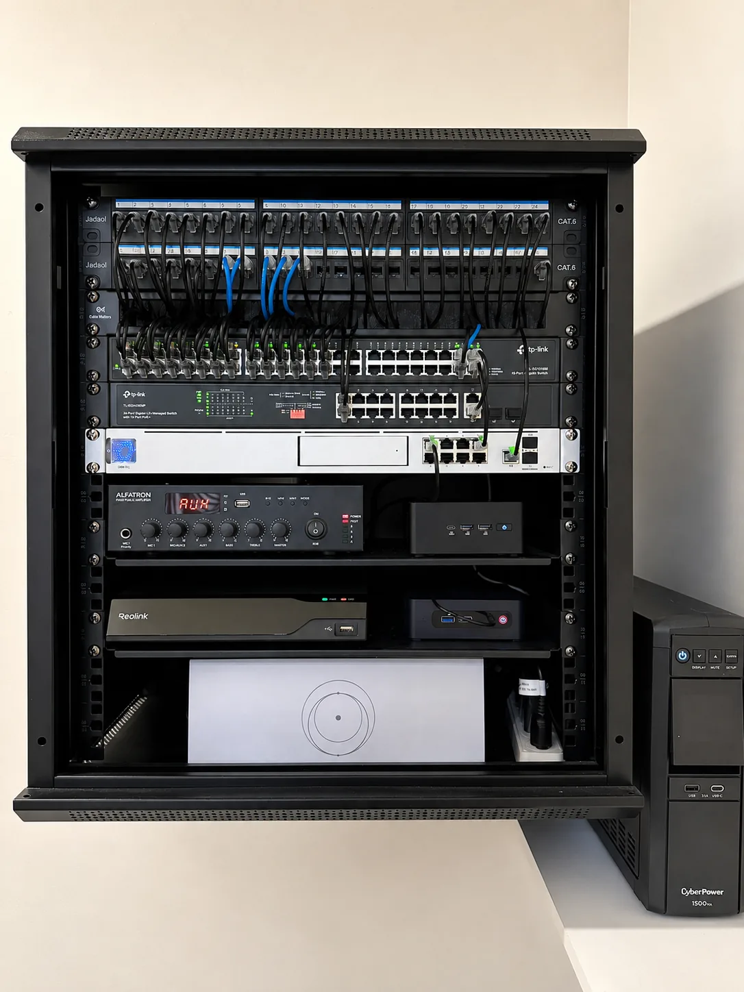 Open network rack with structured cabling, switches, audio, security, and backup power